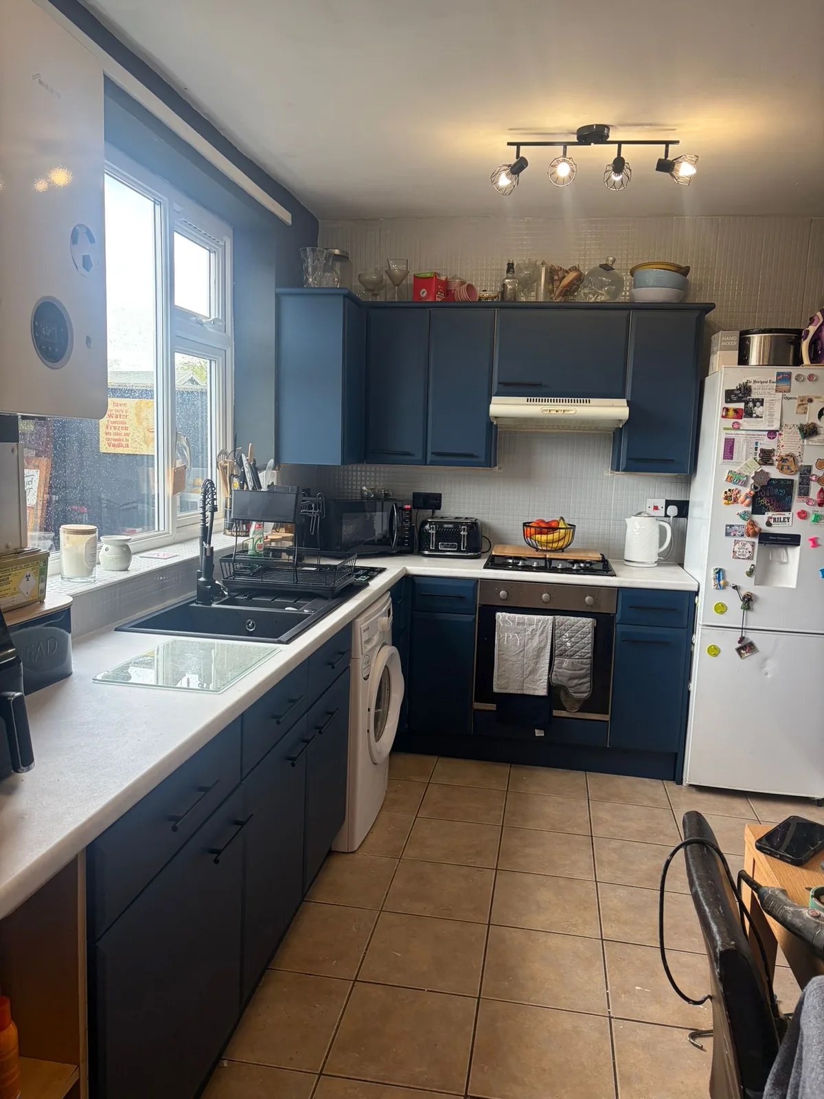 Navy blue wrapped kitchen cabinets with light wrapped worktops in Greater Manchester
