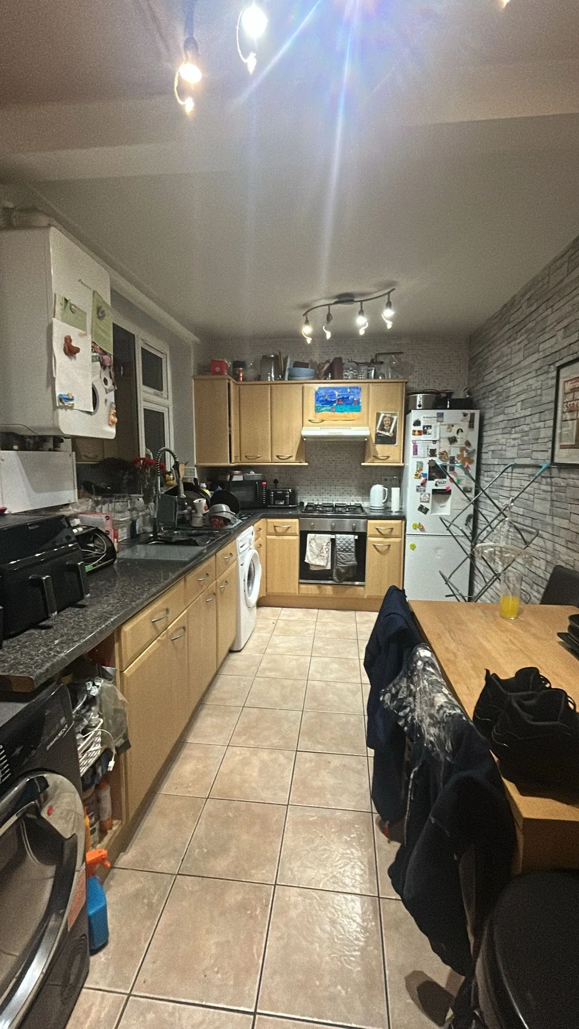 Light wood kitchen with dark laminate worktops before wrapping in Greater Manchester